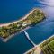 t Aerial view of an island connected by a bridge